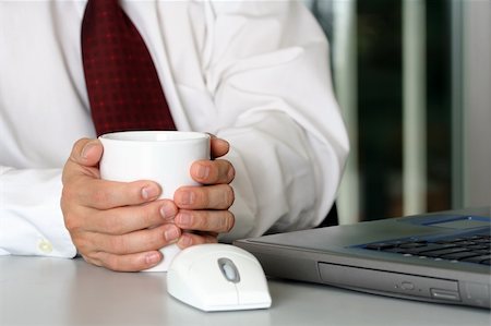 simsearch:400-04591983,k - Businessman with a cup of coffee and laptop Fotografie stock - Microstock e Abbonamento, Codice: 400-05046663