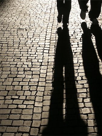 simsearch:695-05777077,k - Two people shadows walking on a cobbled street. Stock Photo - Budget Royalty-Free & Subscription, Code: 400-05046929