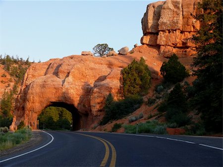 A road going through a tunnel carved out of rock Foto de stock - Super Valor sin royalties y Suscripción, Código: 400-05047864