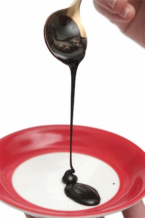 Drops of chocolate on the spoon and a plate Stockbilder - Microstock & Abonnement, Bildnummer: 400-05048972