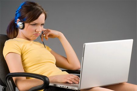 simsearch:400-03996848,k - nice girl sitting with the laptop on her legsand making face at computer Fotografie stock - Microstock e Abbonamento, Codice: 400-05040015