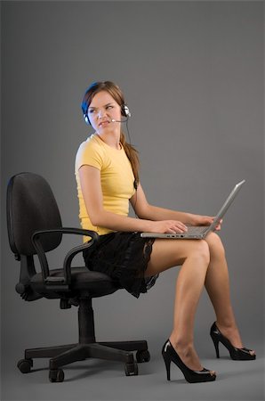 simsearch:400-03996848,k - secretary with computer on legs looking angry against somebody Fotografie stock - Microstock e Abbonamento, Codice: 400-05040017