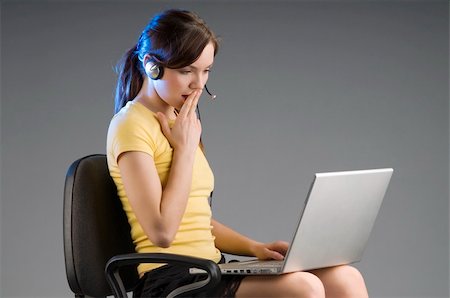 simsearch:400-04504422,k - cute office worker with earphone looking the laptop with surprise Photographie de stock - Aubaine LD & Abonnement, Code: 400-05040012