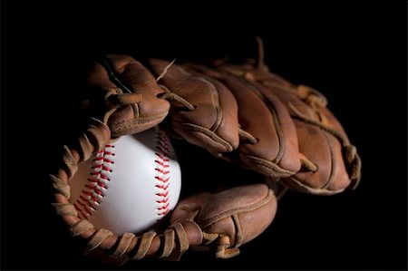 A baseball in a glove sitting on a black reflective surface. Stock Photo - Budget Royalty-Free & Subscription, Code: 400-05041049