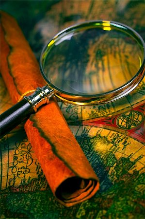 Magnifying glass, scroll, and map with antique look Stock Photo - Budget Royalty-Free & Subscription, Code: 400-05041421