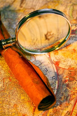 Magnifying glass, scroll, and map with antique look Stock Photo - Budget Royalty-Free & Subscription, Code: 400-05041422