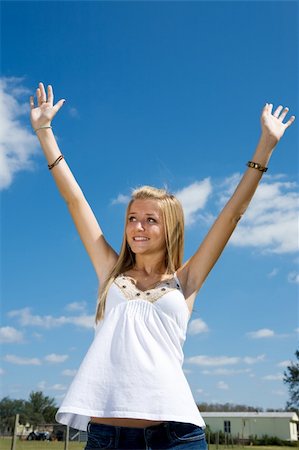 portrait photo teenage girl long blonde hair'''' - Blond teen girl outdoors raising her arms in praise. Stock Photo - Budget Royalty-Free & Subscription, Code: 400-05042156
