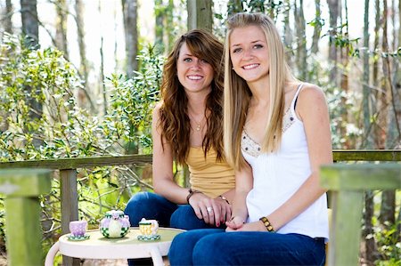 portrait photo teenage girl long blonde hair'''' - Teen sisters in their childhood treehouse having a tea party.  Focus on darker haired girl in center of frame. Stock Photo - Budget Royalty-Free & Subscription, Code: 400-05042159