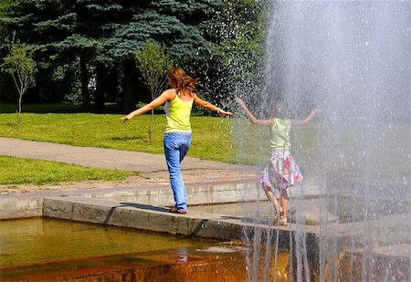 The girl and the girl smoothly come up from a veil of a fountain. A city landscape, a bright warm years sunny day. Stock Photo - Budget Royalty-Free & Subscription, Code: 400-05042355