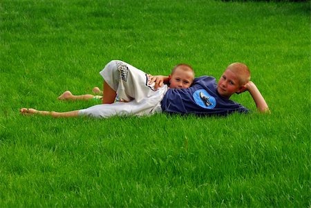 simsearch:400-05875962,k - young brothers are resting on the grass in the garden Photographie de stock - Aubaine LD & Abonnement, Code: 400-05043059