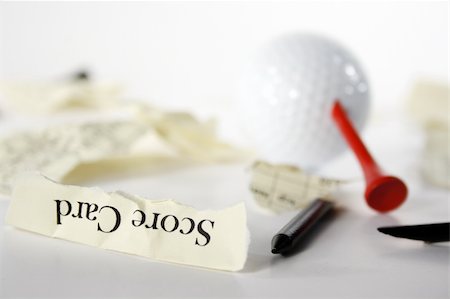 Golf score card teared apart, with peg through ball, due to bad result Foto de stock - Royalty-Free Super Valor e Assinatura, Número: 400-05043905