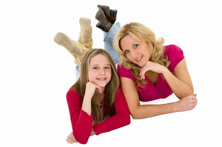 Mother and daughter laying on a white background together in casual clothing Stock Photo - Budget Royalty-Free & Subscription, Code: 400-05054012