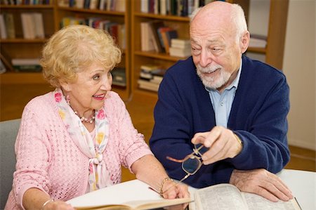 public relations - Senior man and woman meeting at the library and discussing books. Photographie de stock - Aubaine LD & Abonnement, Code: 400-05054053