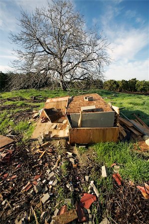 reclaimer - After a storm, light was excellent.  Near old abandoned home is this debris with a tree near an orange groove. Stock Photo - Budget Royalty-Free & Subscription, Code: 400-05054804