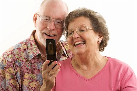 simsearch:400-04522125,k - Senior Couple looks at the screen of a cell phone. Stock Photo - Budget Royalty-Free & Subscription, Code: 400-05055330