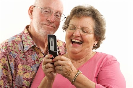 simsearch:400-04522125,k - Senior Couple looks at the screen of a cell phone. Stock Photo - Budget Royalty-Free & Subscription, Code: 400-05055331