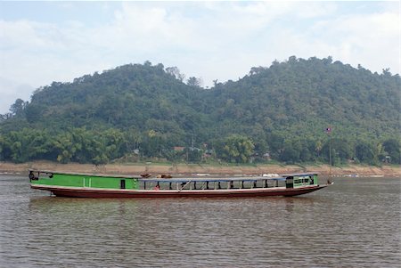 Long boat on the river in Laos Stock Photo - Budget Royalty-Free & Subscription, Code: 400-05055884