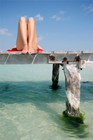 simsearch:400-04018254,k - One of a large series. Woman in red bikini sunbathing on a tropical jetty Stockbilder - Microstock & Abonnement, Bildnummer: 400-05056912