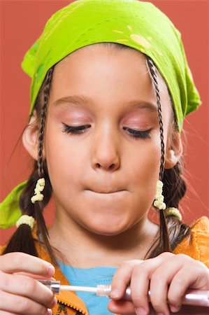 young pretty child applying make-up Stock Photo - Budget Royalty-Free & Subscription, Code: 400-05057431