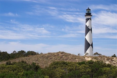 A historic lighthouse guiding ships away from rocky shoals. Stock Photo - Budget Royalty-Free & Subscription, Code: 400-05058102