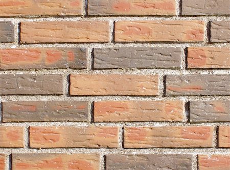 Piece of a wall build of hard burned, hand moulded bricks with a rough surface. This structure will make a nice background for your own 'grafitti' illustration or text. Fotografie stock - Microstock e Abbonamento, Codice: 400-05058326