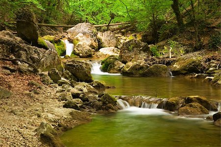 The mountain river flows on boulders in gorge forming the threefold cascade. Stock Photo - Budget Royalty-Free & Subscription, Code: 400-05059632