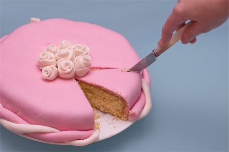 closeup of a cake. Hand cutting a slice with a knife. Fondant cake made with marshmallows Stock Photo - Budget Royalty-Free & Subscription, Code: 400-05059747