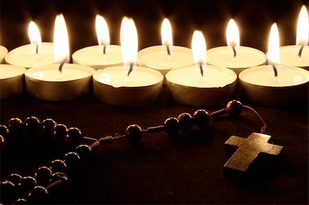 prayer candle and cross - a crucifix in front of a row of candles Stock Photo - Budget Royalty-Free & Subscription, Code: 400-05051379