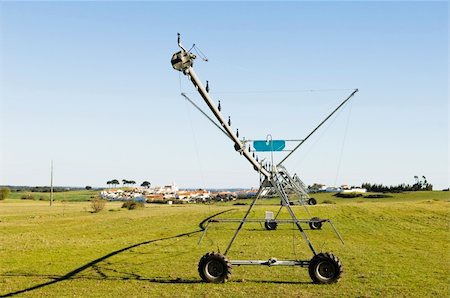 Resting irrigation pivot in a green grass field near a small village. Alentejo, Portugal Stock Photo - Budget Royalty-Free & Subscription, Code: 400-05051765