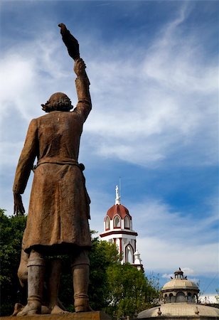 Statue of Miguel Hidalgo in Public Park with Churches in Backgroud, Tlaquepaque, Guadalajara, Mexico.  Father Hidalgo was one of the heroes of the Mexican War of Independence in the early 1800s. Stock Photo - Budget Royalty-Free & Subscription, Code: 400-05052222