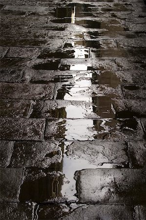 puddle in the rain - Refections on a wet paved city street Stock Photo - Budget Royalty-Free & Subscription, Code: 400-05052354