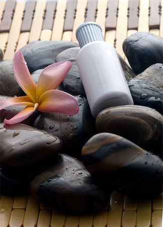 Aromatherapy and spa massage on tropical bamboo and polished stones. Stockbilder - Microstock & Abonnement, Bildnummer: 400-05052404