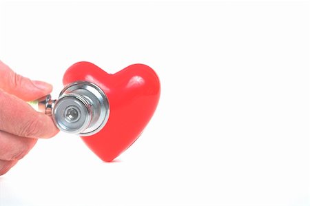 simsearch:400-05052842,k - A red heart shape and a medical stethoscope. Photographie de stock - Aubaine LD & Abonnement, Code: 400-05052843