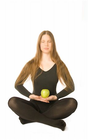 simsearch:400-04596923,k - The portrait of a woman in lotus pose with a green apple in her hands Stock Photo - Budget Royalty-Free & Subscription, Code: 400-05052876