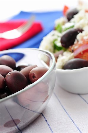 person eating greek salad - Black kalamata olives and greek salad with feta cheese Stock Photo - Budget Royalty-Free & Subscription, Code: 400-05052933