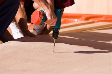 A builder using a powertool to screw a screw in Stock Photo - Budget Royalty-Free & Subscription, Code: 400-05053062