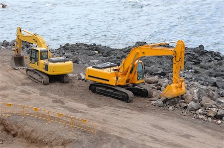 Two orange excavators near the sea Stock Photo - Budget Royalty-Free & Subscription, Code: 400-05053447