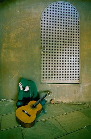 photographic portraits poor people - Young guitar performer in urban background. Cross processed. Stock Photo - Budget Royalty-Free & Subscription, Code: 400-05064592