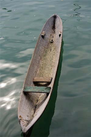 photo of empty canoe on water - Hand carved dug out canoe Stock Photo - Budget Royalty-Free & Subscription, Code: 400-05064806