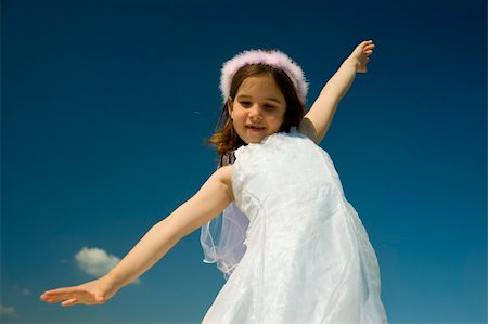 simsearch:400-04662543,k - young girl with spreads arms against blue sky Stock Photo - Budget Royalty-Free & Subscription, Code: 400-05065804