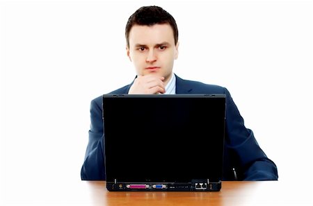 simsearch:400-04631810,k - Young businessman thinking behind the computer (focus on computer) Stock Photo - Budget Royalty-Free & Subscription, Code: 400-05065970