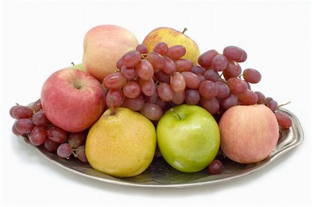 Fresh fruit on the large plate on a white background. Foto de stock - Royalty-Free Super Valor e Assinatura, Número: 400-05066316