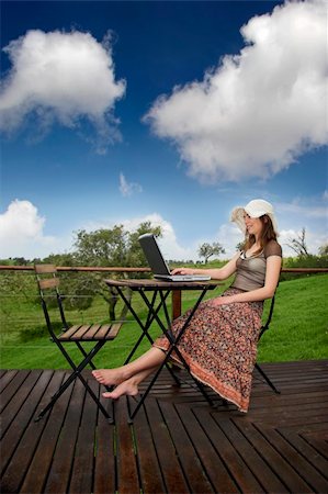 Woman enjoying a beautiful day with a laptop on her home-field Stock Photo - Budget Royalty-Free & Subscription, Code: 400-05066751
