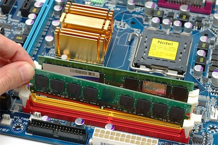 Installing computer ram on a motherboard Stock Photo - Budget Royalty-Free & Subscription, Code: 400-05066875