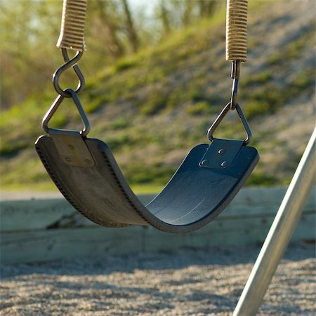 empty playground - A single swing, sitting empty on a playground Stock Photo - Budget Royalty-Free & Subscription, Code: 400-05067971