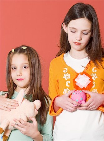 sibling sad - Two girl holding they're toy banks Stock Photo - Budget Royalty-Free & Subscription, Code: 400-05068049