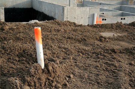 An exposed pipe at a new construction site. Fotografie stock - Microstock e Abbonamento, Codice: 400-05068199
