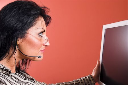 sales call training - Surprised woman with headset looking at the computer monitor Stock Photo - Budget Royalty-Free & Subscription, Code: 400-05068308