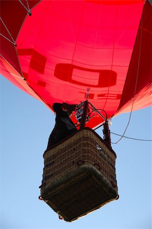 A man is standing in his hot air balloon waving with his hand. Stock Photo - Budget Royalty-Free & Subscription, Code: 400-05068737