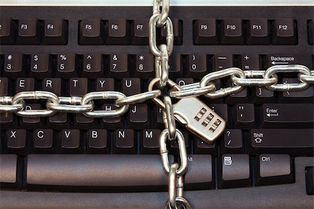 Computer Keyboard secured with lock and chain Stock Photo - Budget Royalty-Free & Subscription, Code: 400-05068877